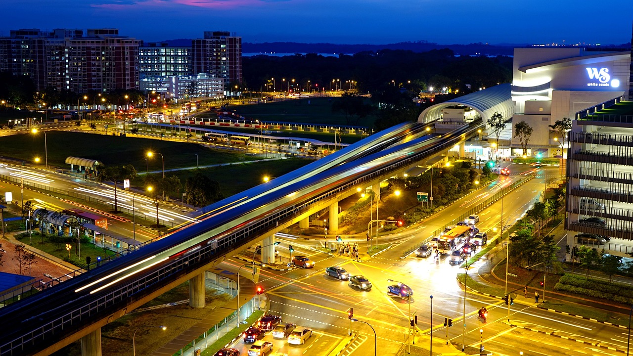 MRT train passing HDB flats at night in Singapore — best credit cards for bus and MRT rides