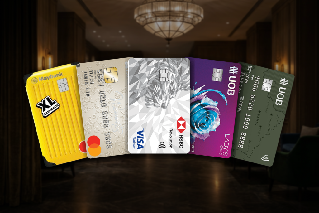 Best credit cards for hotel bookings in Singapore 2026 — HSBC Revolution, DBS Woman's World, UOB Lady's, Maybank XL Cashback and UOB Visa Signature cards in a hotel lobby