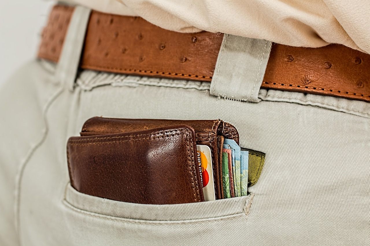 man with a wallet full of cash and cards
