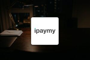 iPayMy logo on a desk at night, for a guide to paying rent, insurance and taxes by credit card