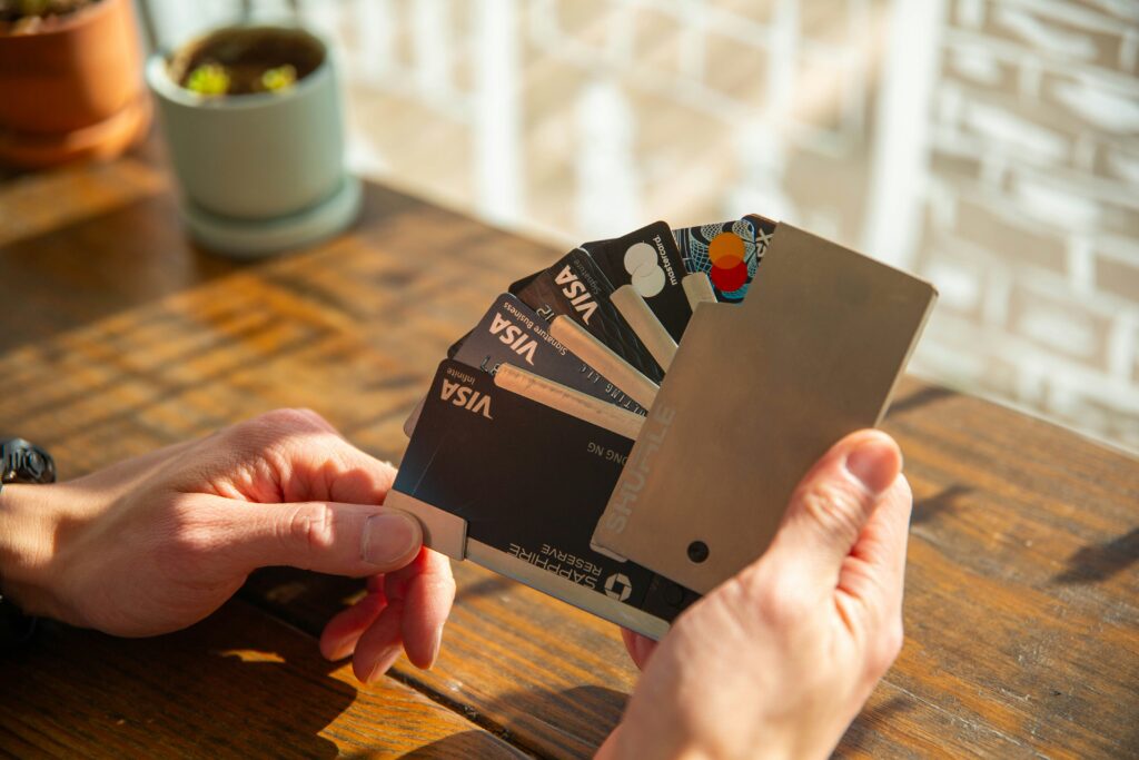 hand holding multiple credit cards on a card holder