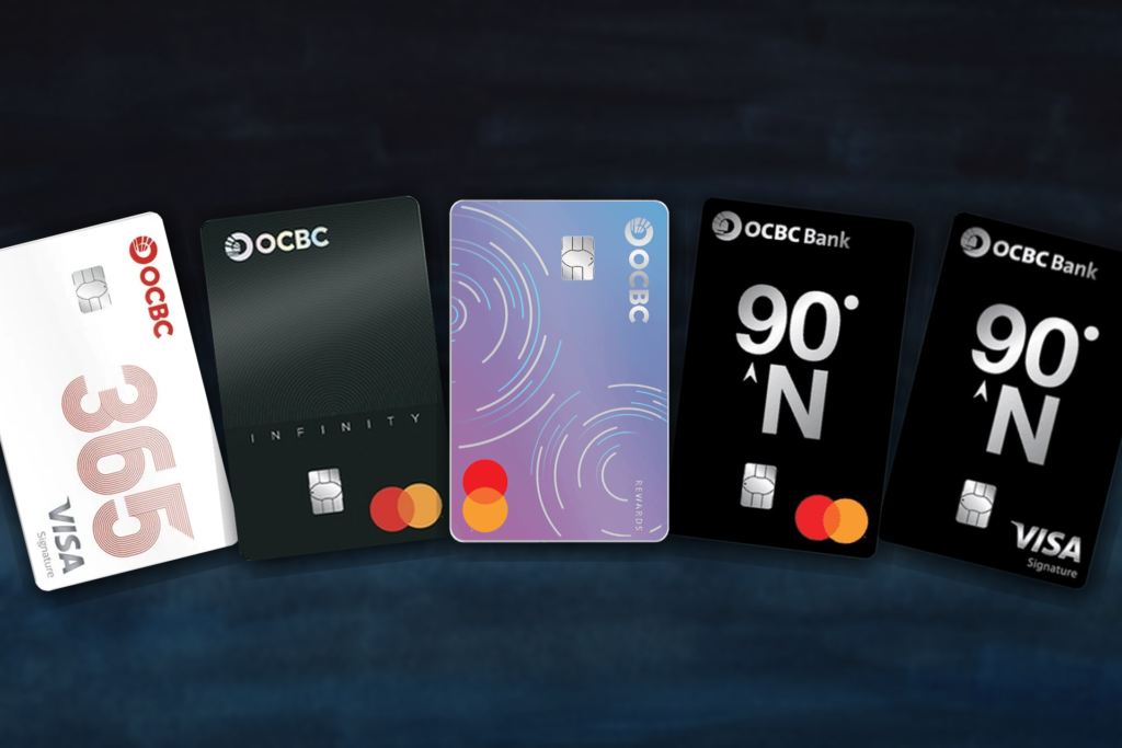 Row of OCBC bank cards fanned out on a dark blue background showing different designs and logos VisaMastercard