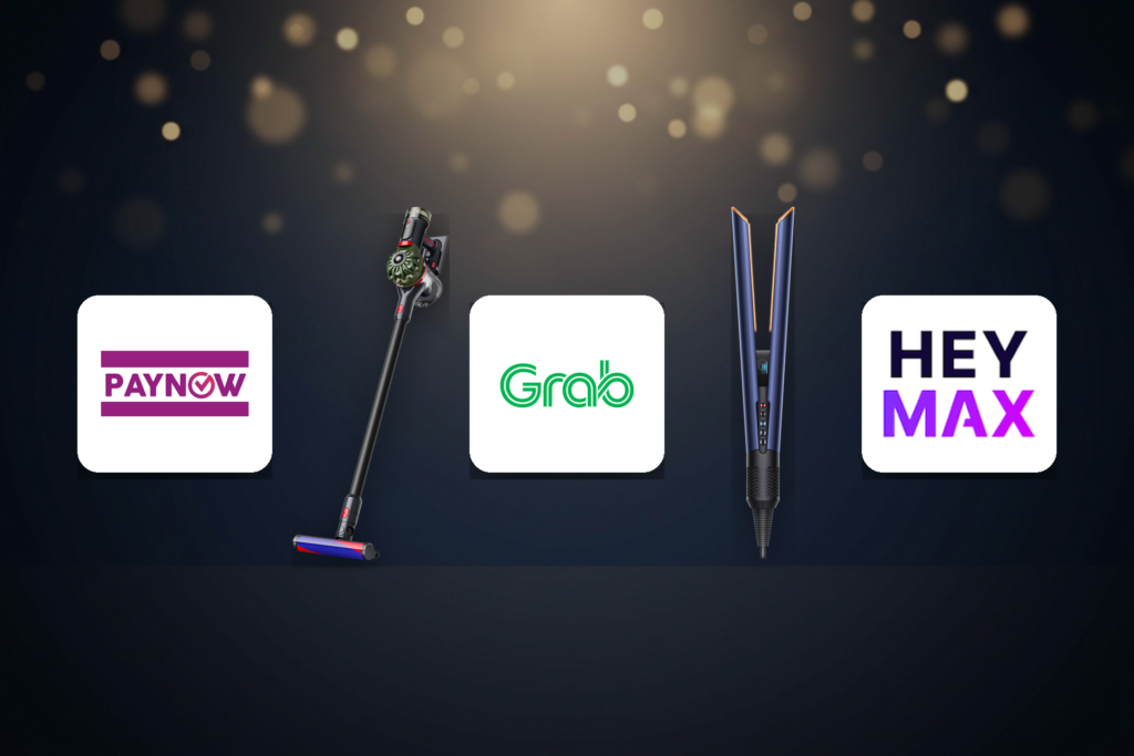 Promotional banner showing PayNow Grab and HeyMax logos with a cordless vacuum on the left and a blue hair straightener in the center against a dark bokeh background